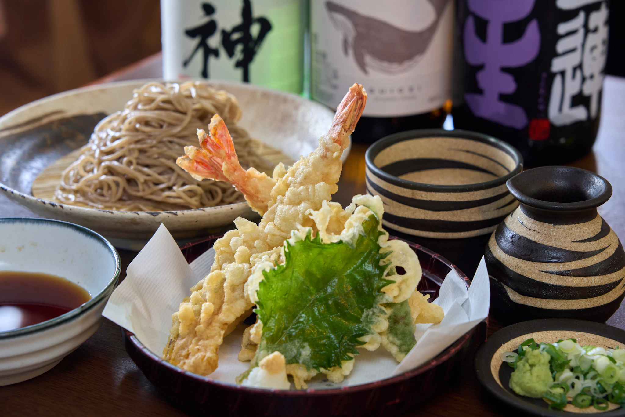 A wooden table topped with plates of food