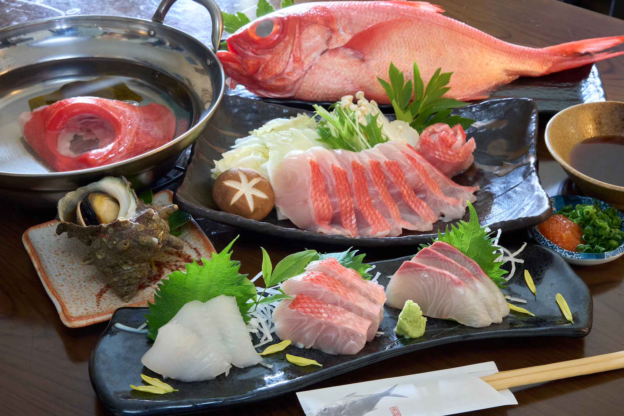 A wooden table topped with plates of food